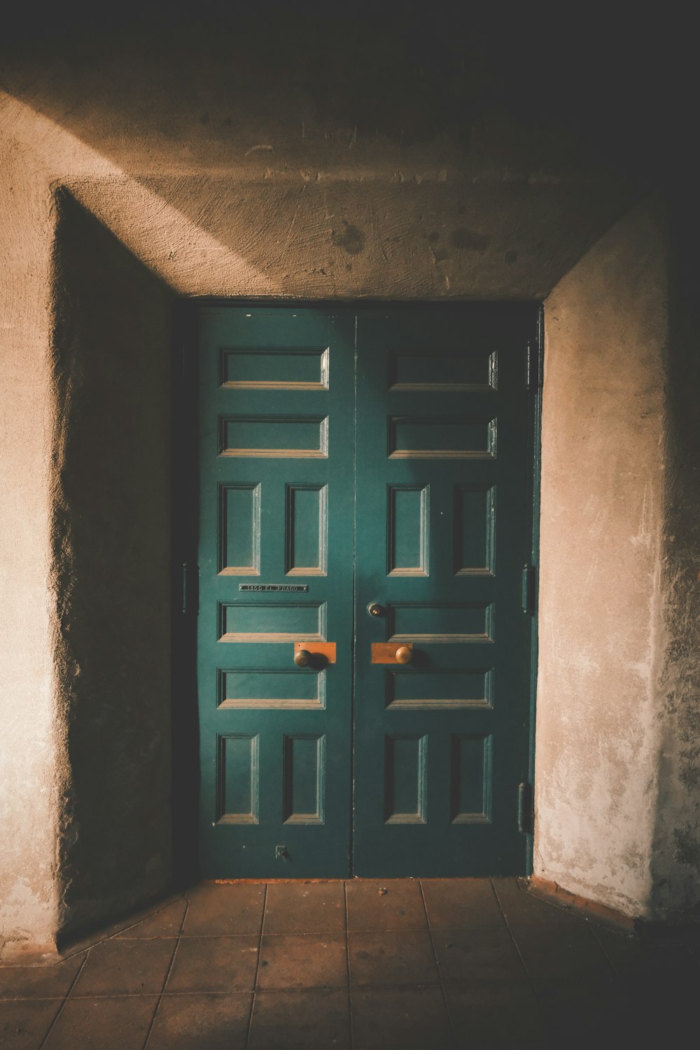 a green door is open in a room