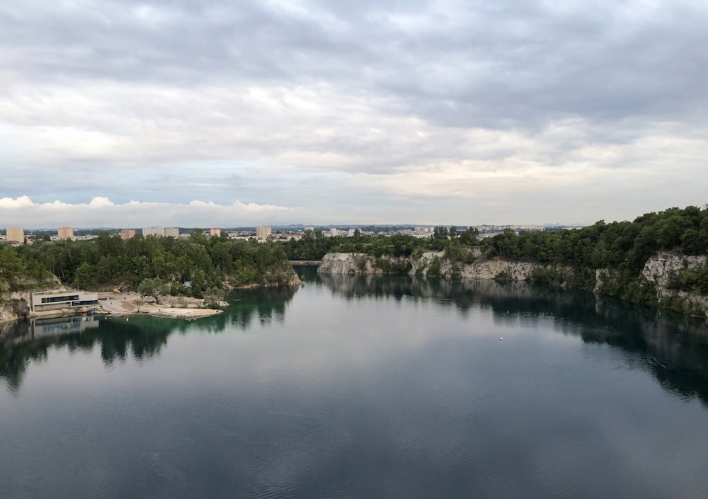 a body of water surrounded by trees and buildings