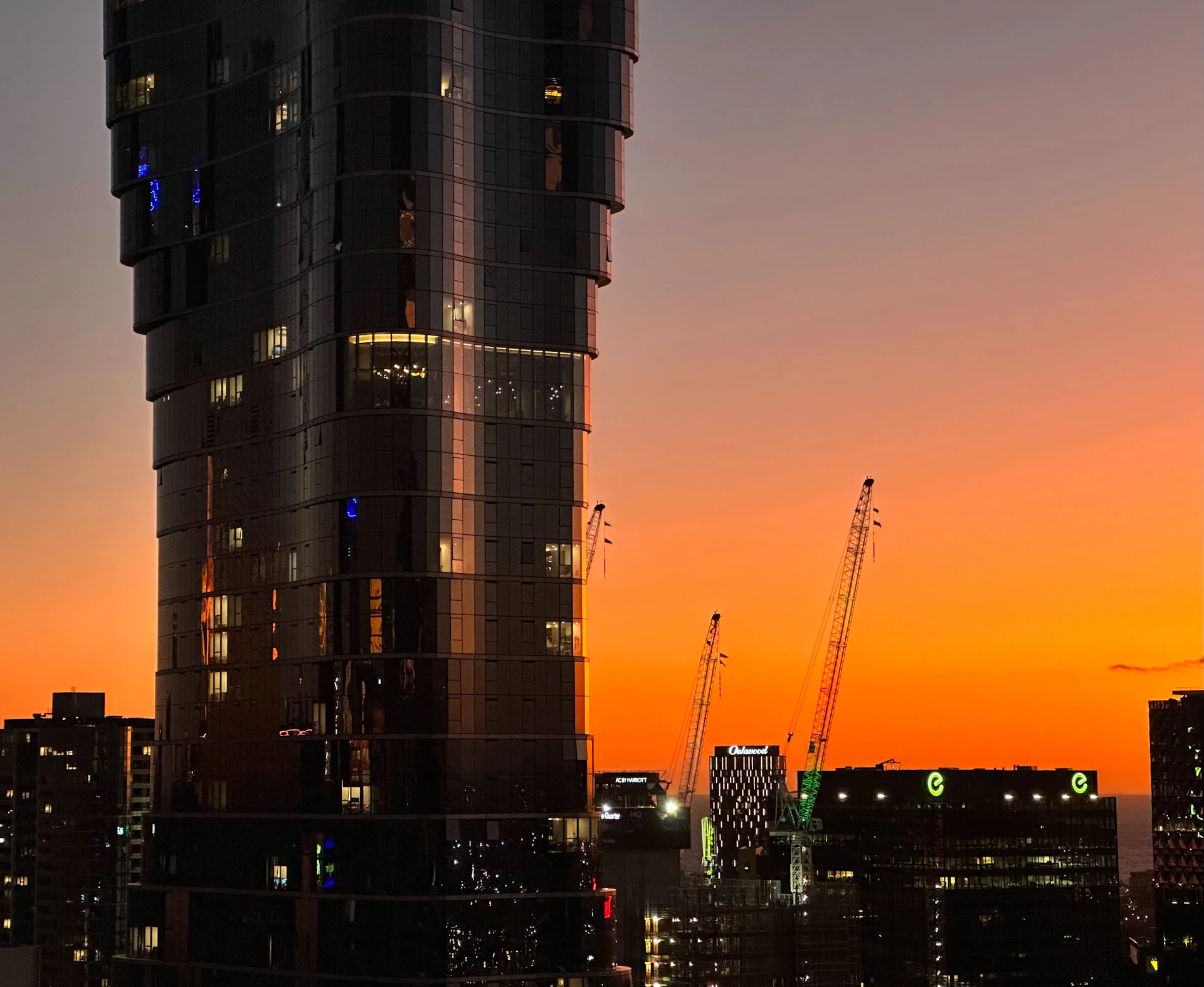 An elegant skyline at dusk featuring cranes and mining machinery, symbolizing JJSR Corporation's impact across India's infrastructure and mining sectors.