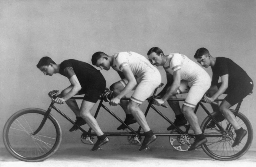 Four men on bicycle built for four