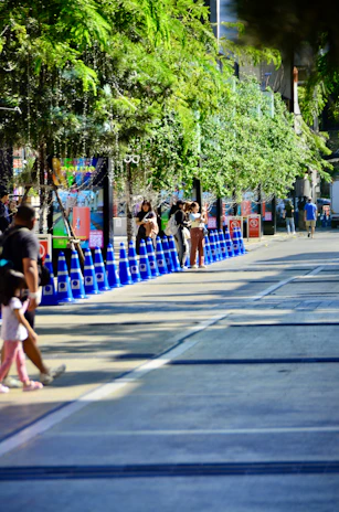 A vibrant display of colorful traffic cones lined up along a busy Mumbai street.
