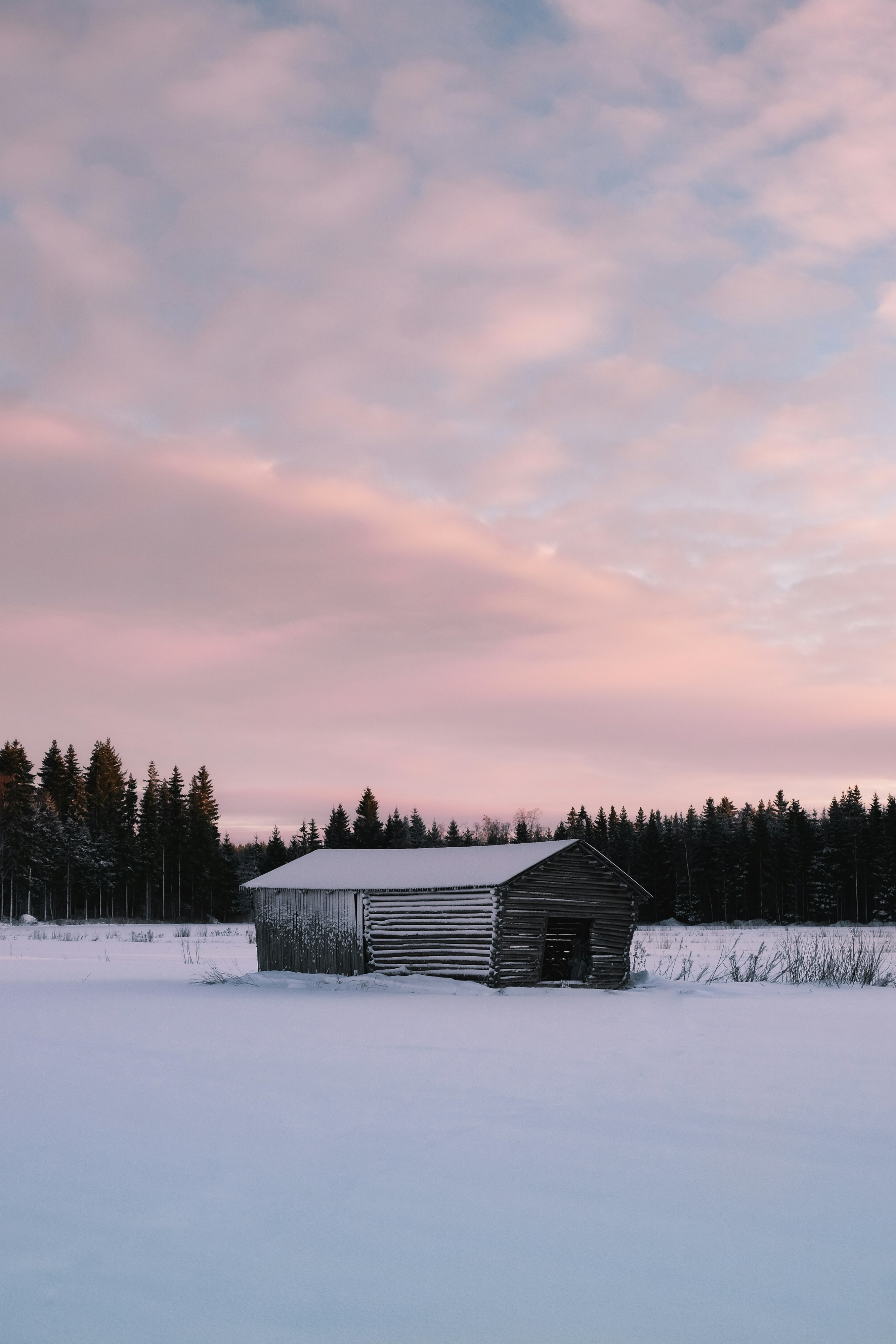 A barn in the middle of a snowy field photo – Free Sunset Image on Unsplash