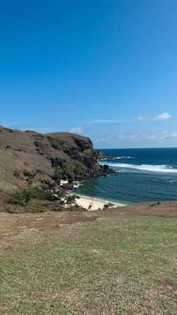 a view of the ocean from the top of a hill