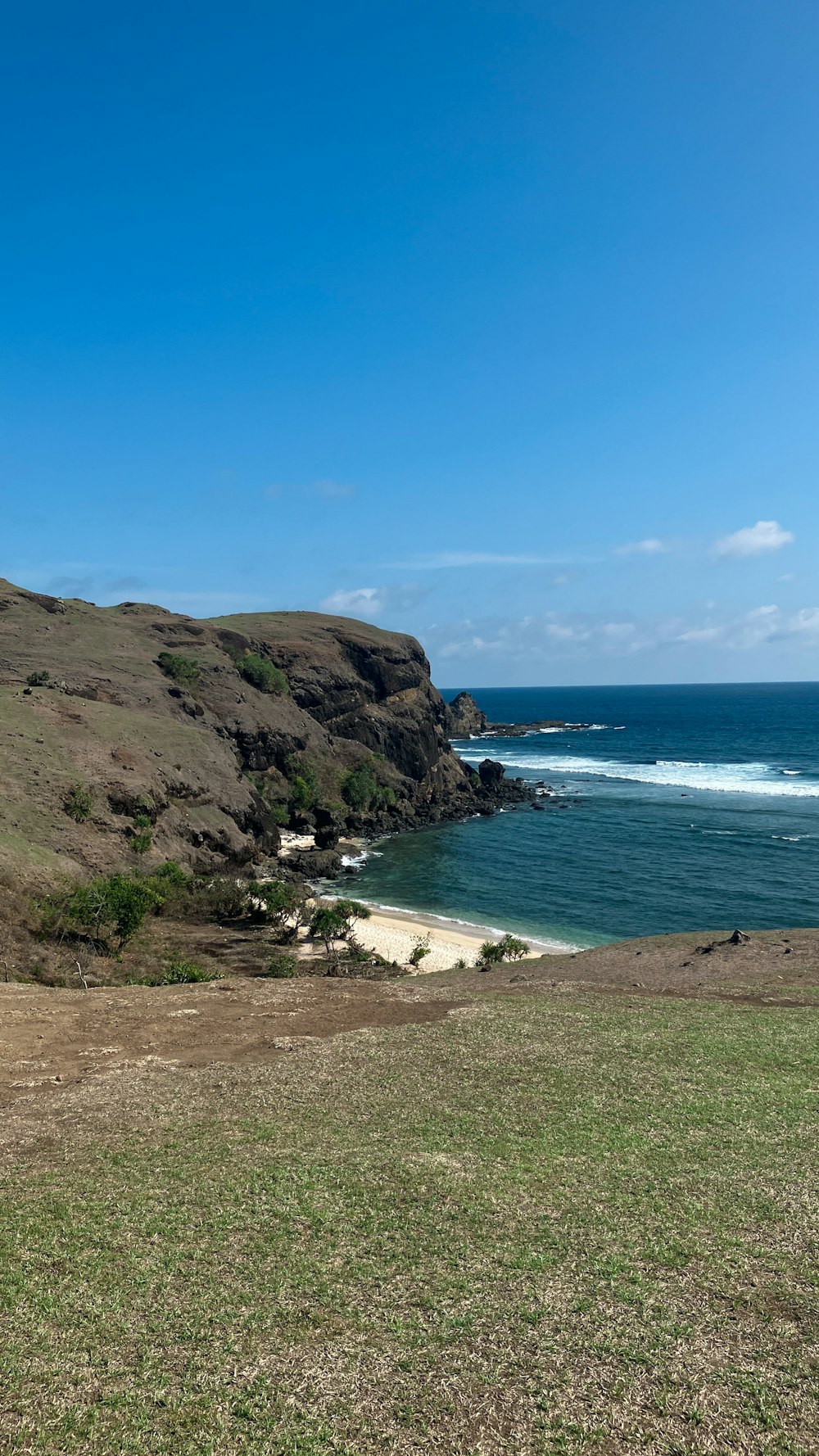 a view of the ocean from the top of a hill