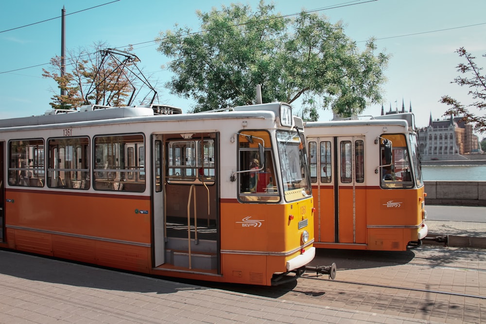 a couple of orange trolleys parked next to each other