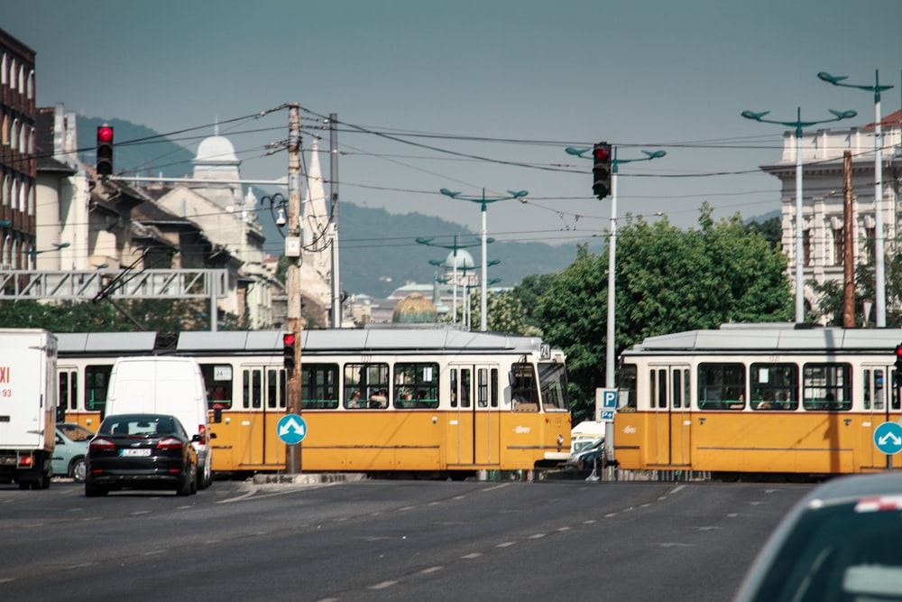 a couple of trains that are sitting in the street