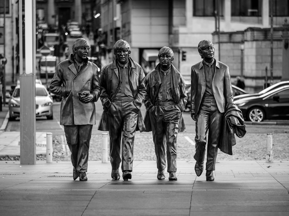 a black and white photo of a group of men walking down the street