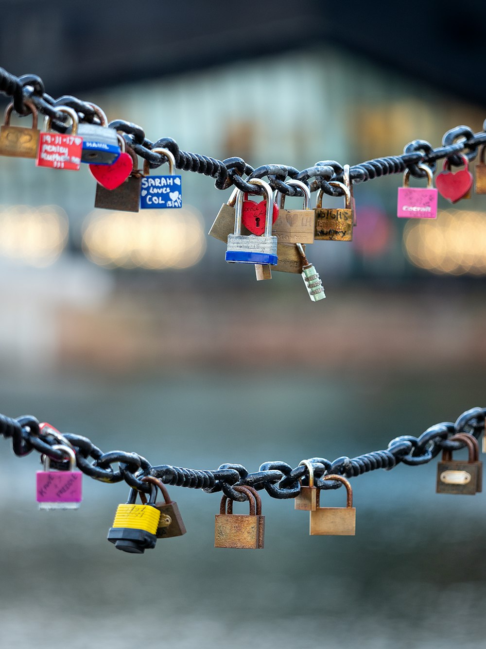 a bunch of padlocks that are attached to a chain