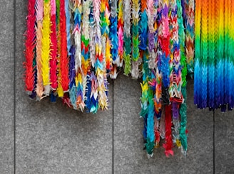 a bunch of colorful streamers hanging on a wall