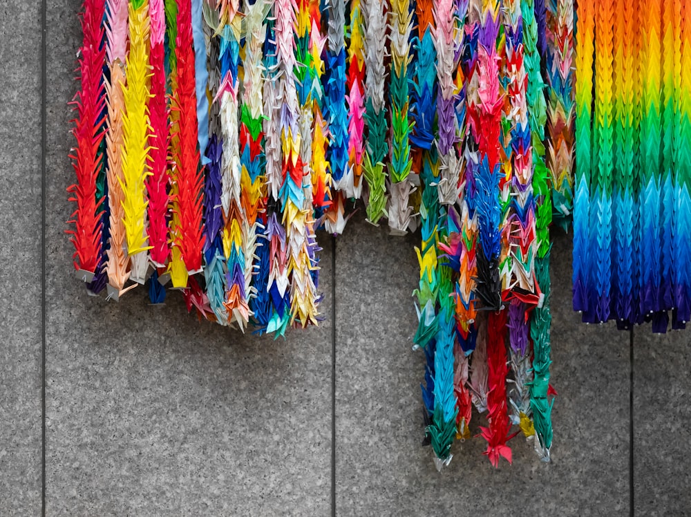 a bunch of colorful streamers hanging on a wall