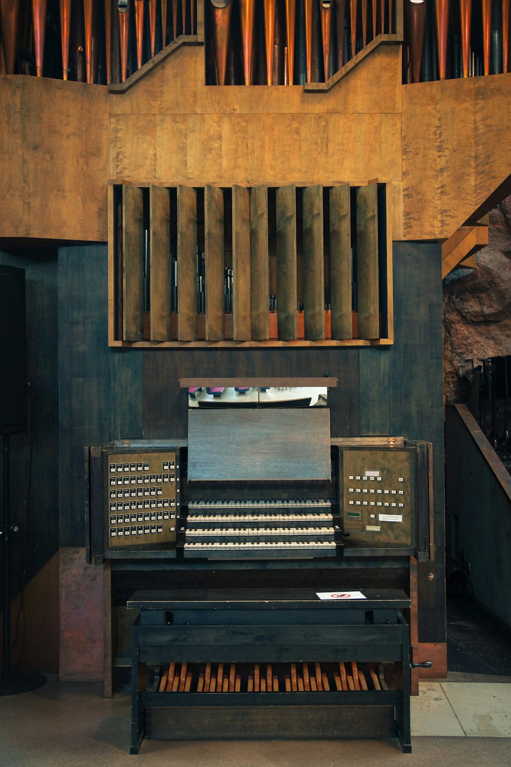 an old typewriter sitting in a room next to a pipe organ