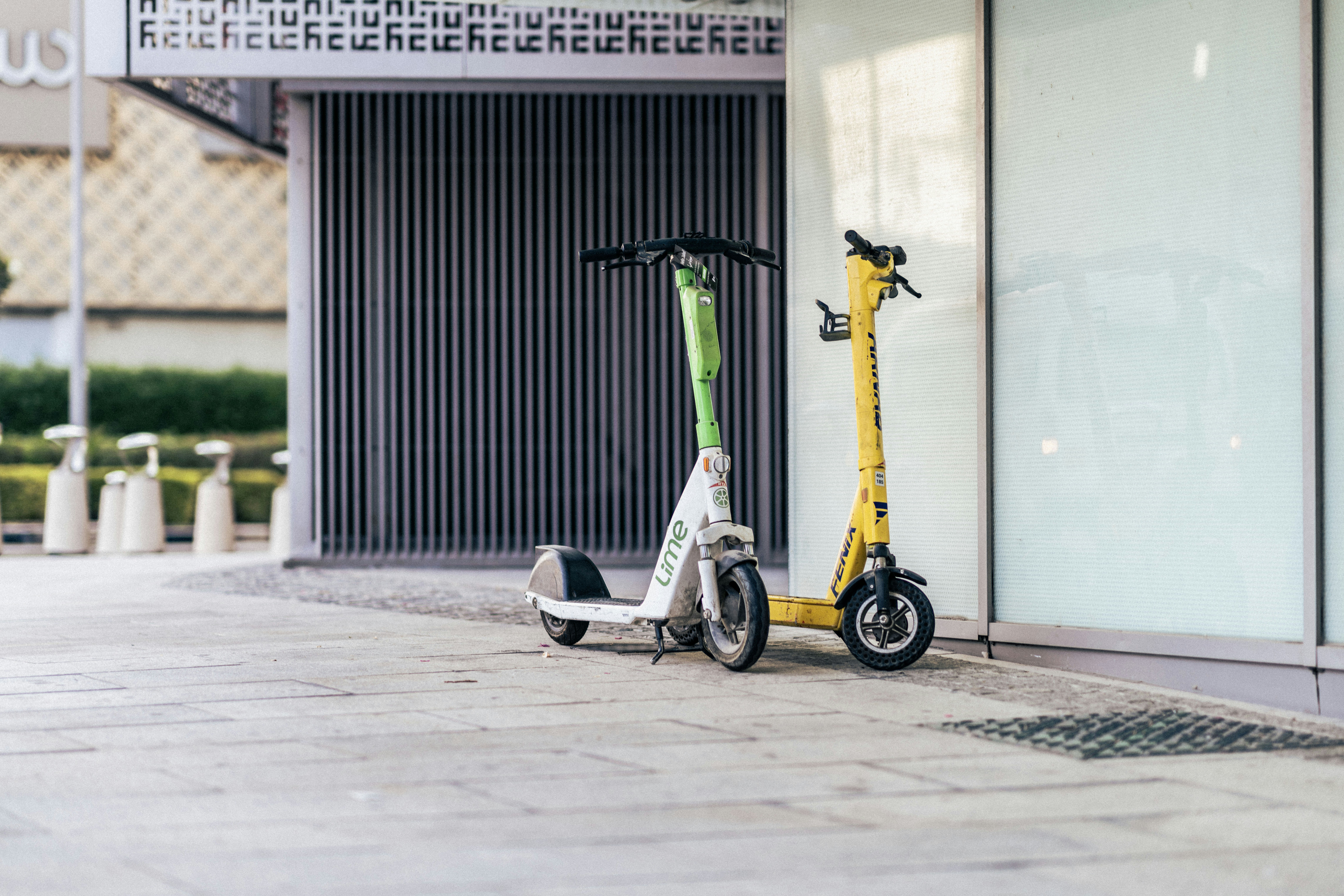 a scooter is parked next to a building aboodi vesakaran (@aboodi_vm)