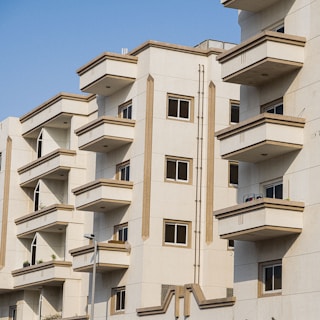 a large white building with balconies and windows