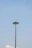 Close-up of a sturdy concrete pole standing tall against a clear blue sky.
