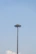 Close-up of a sturdy concrete pole standing tall against a clear blue sky.