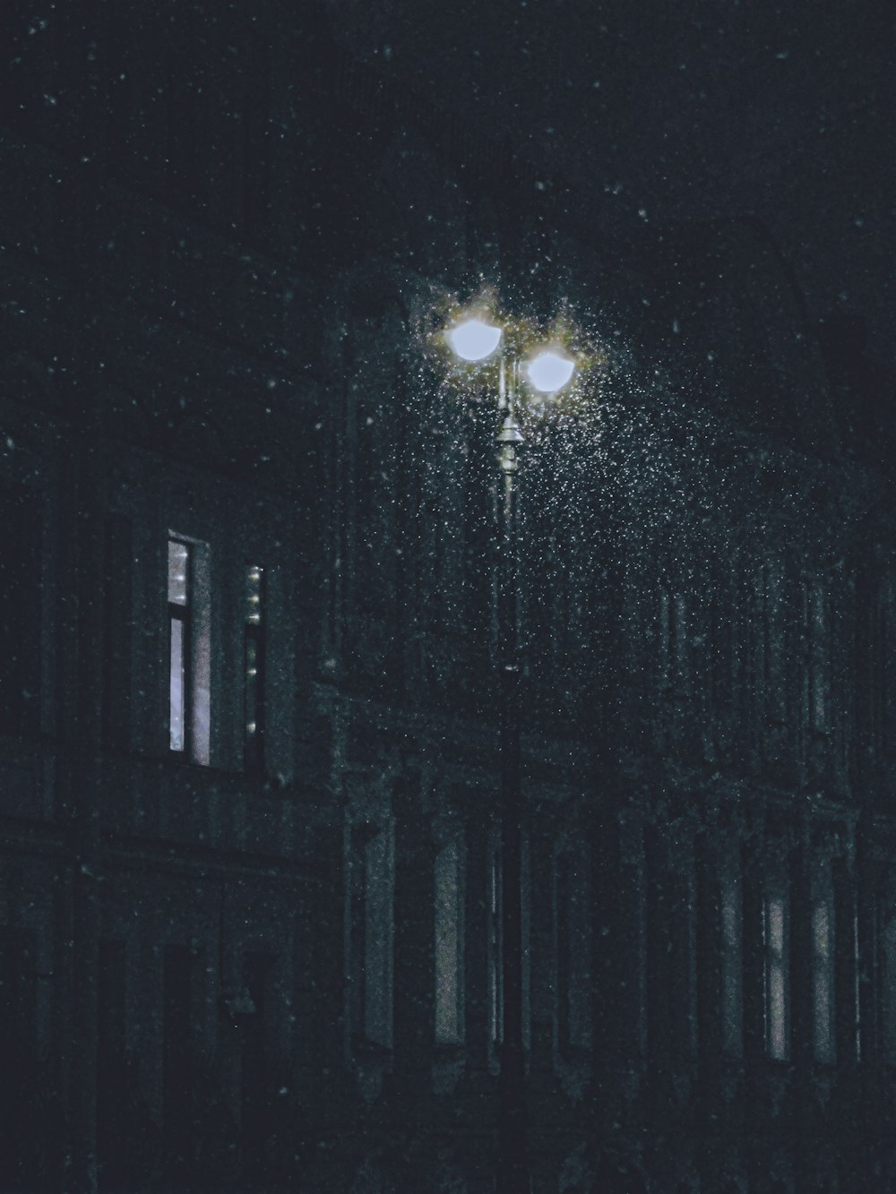 a street light on a dark street at night