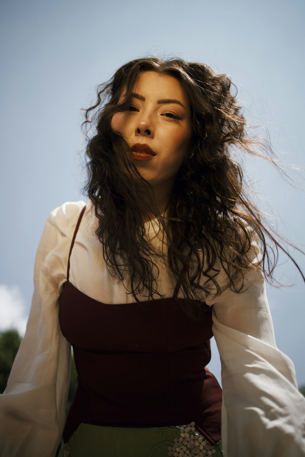 a woman with long hair wearing a dress