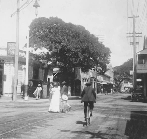 Historic black-and-white photo of Millbrook’s main street bustling with local shops and residents