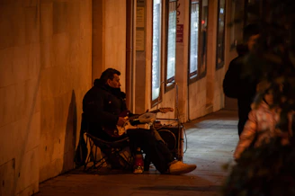 Vintage image of a blues musician playing guitar on a dimly lit street corner