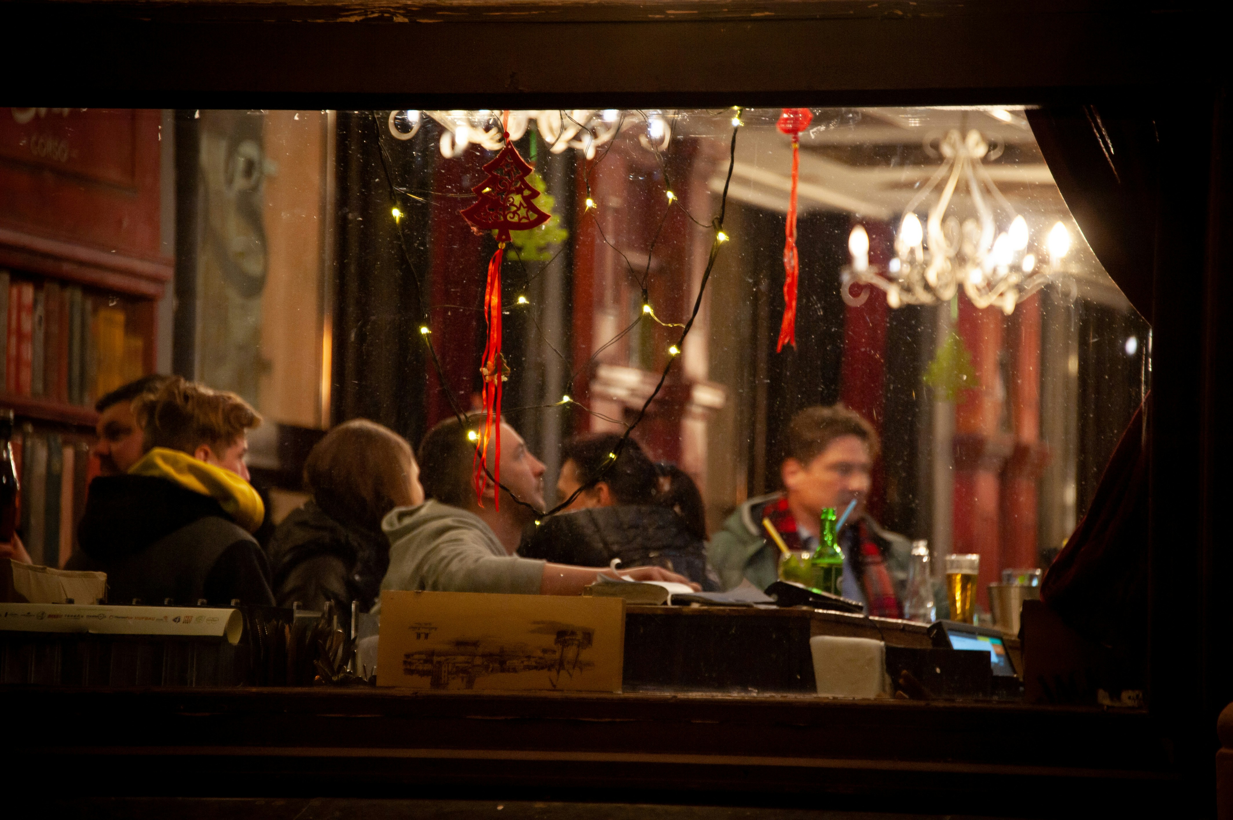 a group of people sitting at a table in a restaurant