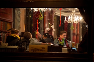A cheerful group of people exchanging gift vouchers in a cozy café setting