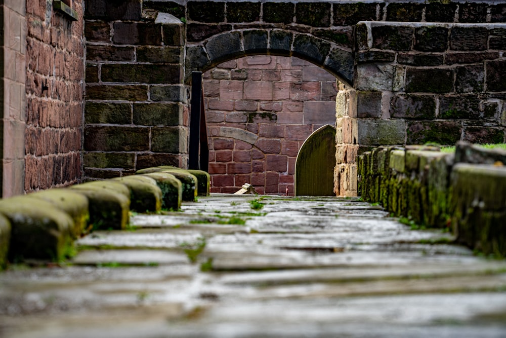 a brick wall with a stone arch in the middle of it