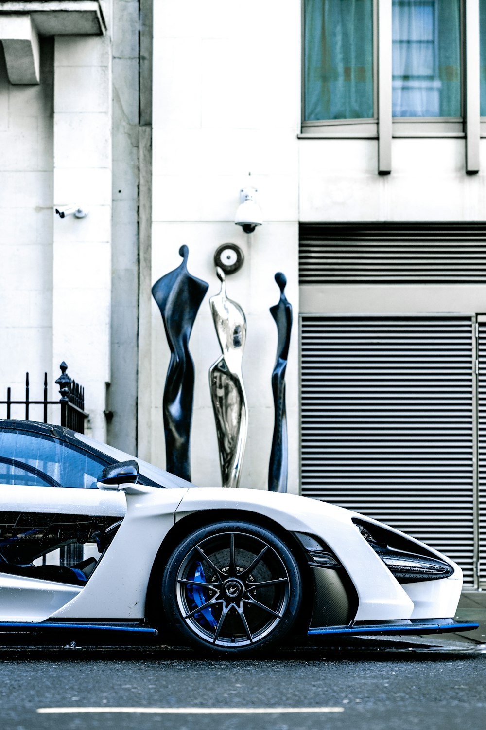 a white sports car parked in front of a building