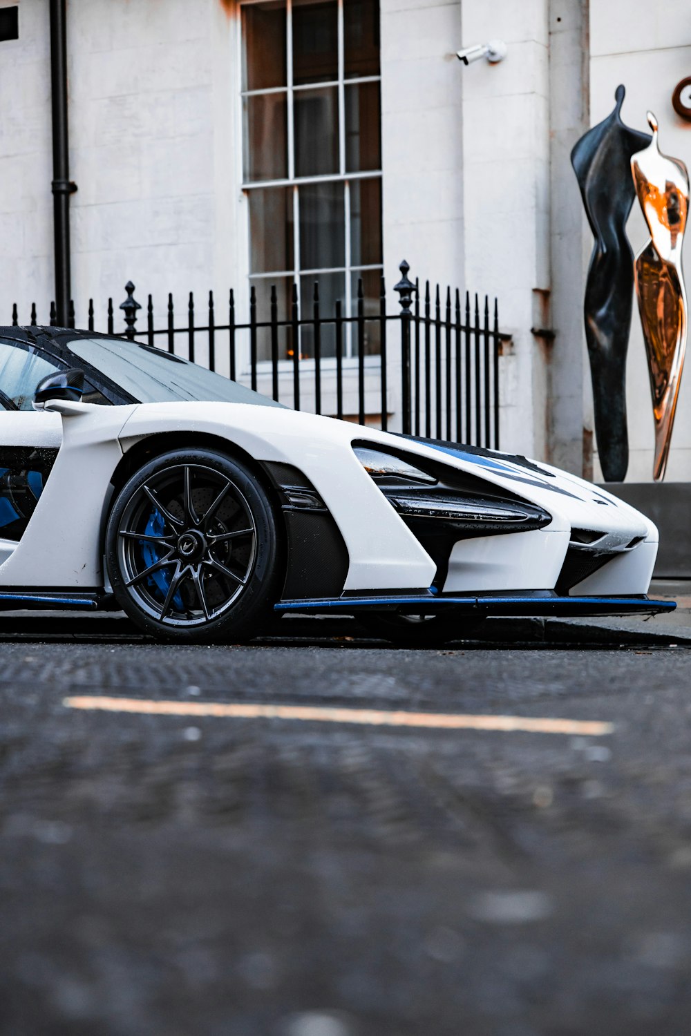 a white sports car parked in front of a building