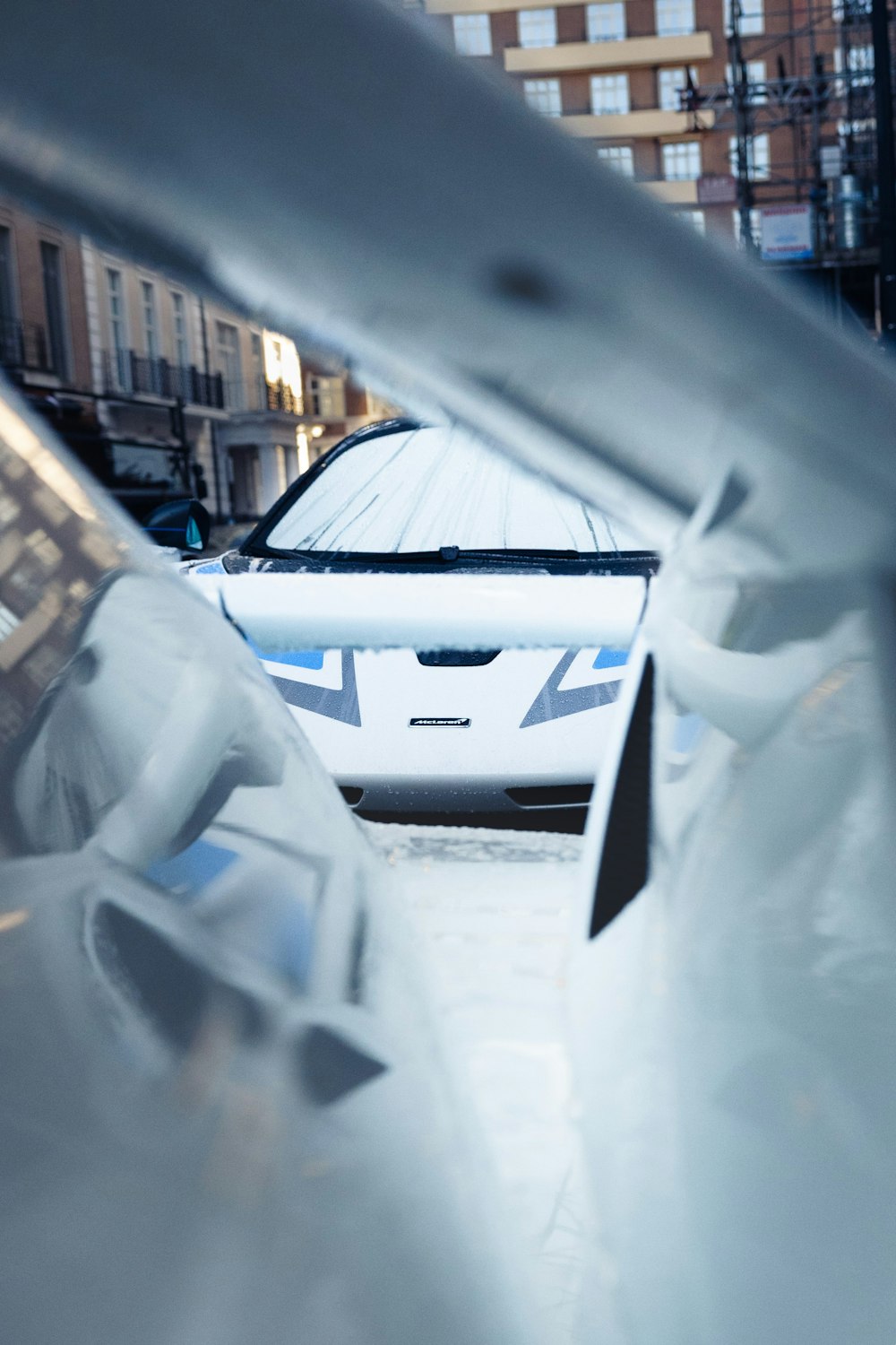 a white car parked in a parking lot next to a building