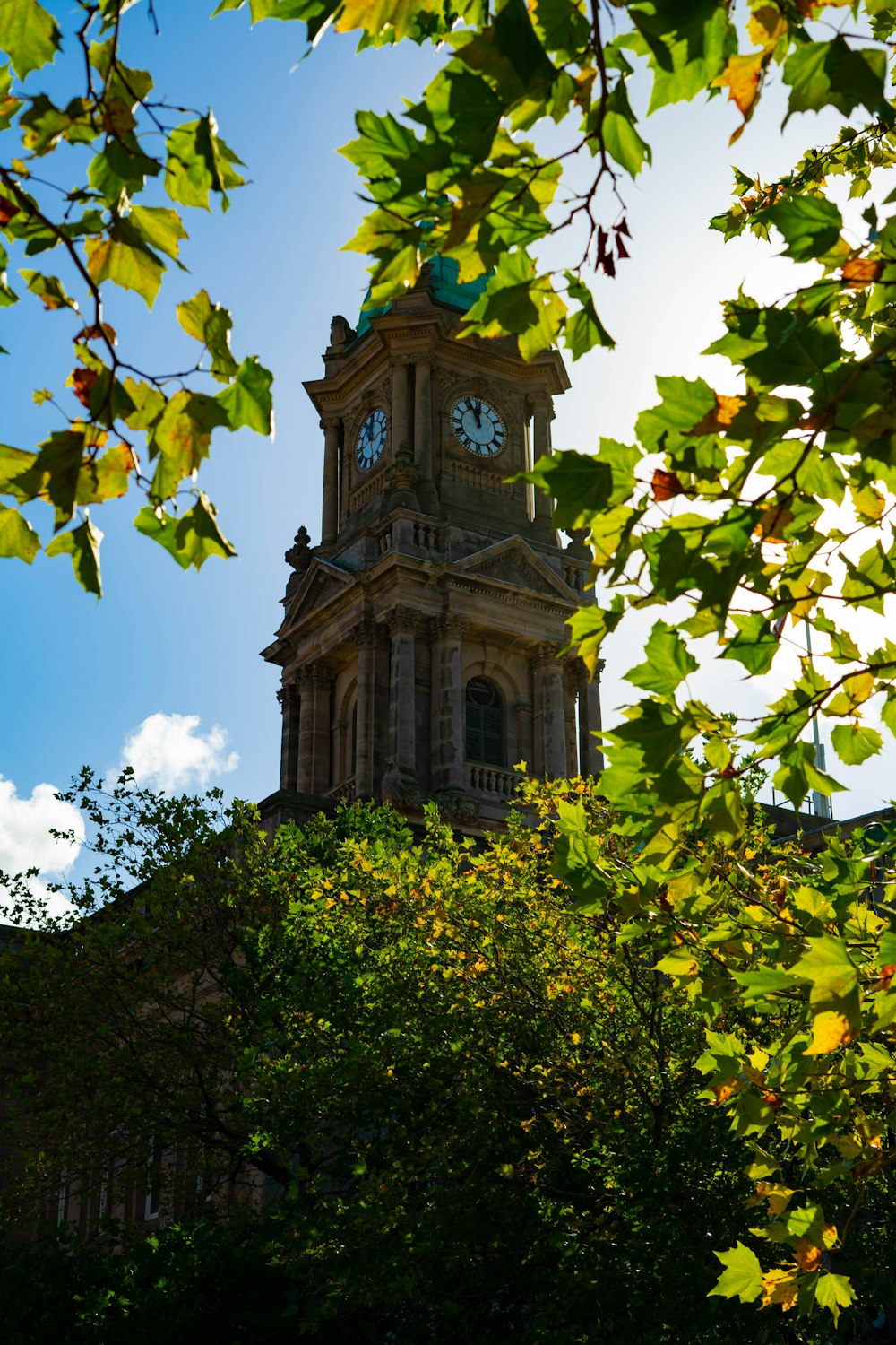 a tall clock tower with a clock on each of it's sides