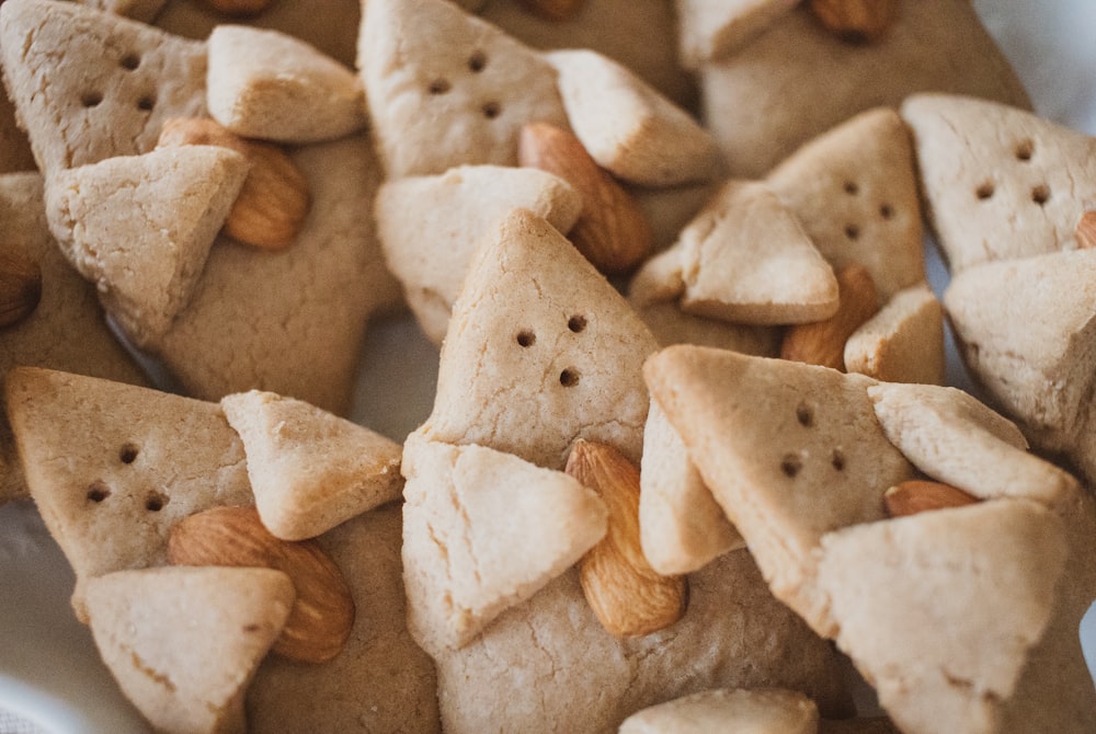 a close up of a plate of cookies with almonds