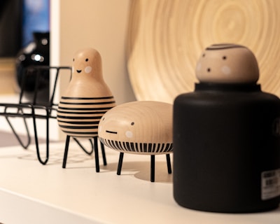 Hand-painted wooden figurines with charming, whimsical expressions.