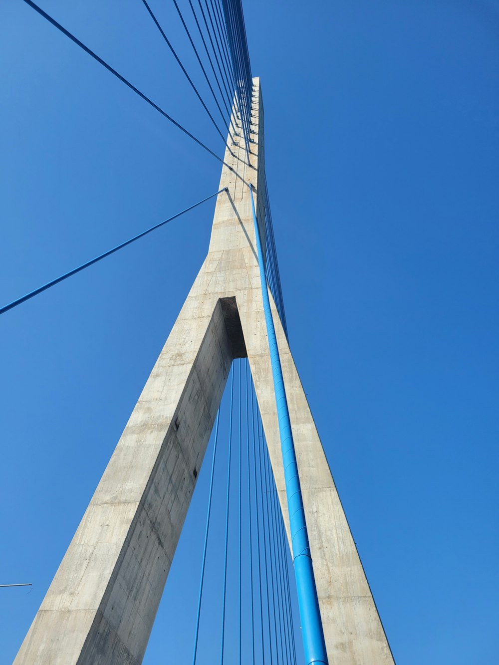 a very tall bridge with a very tall blue pole
