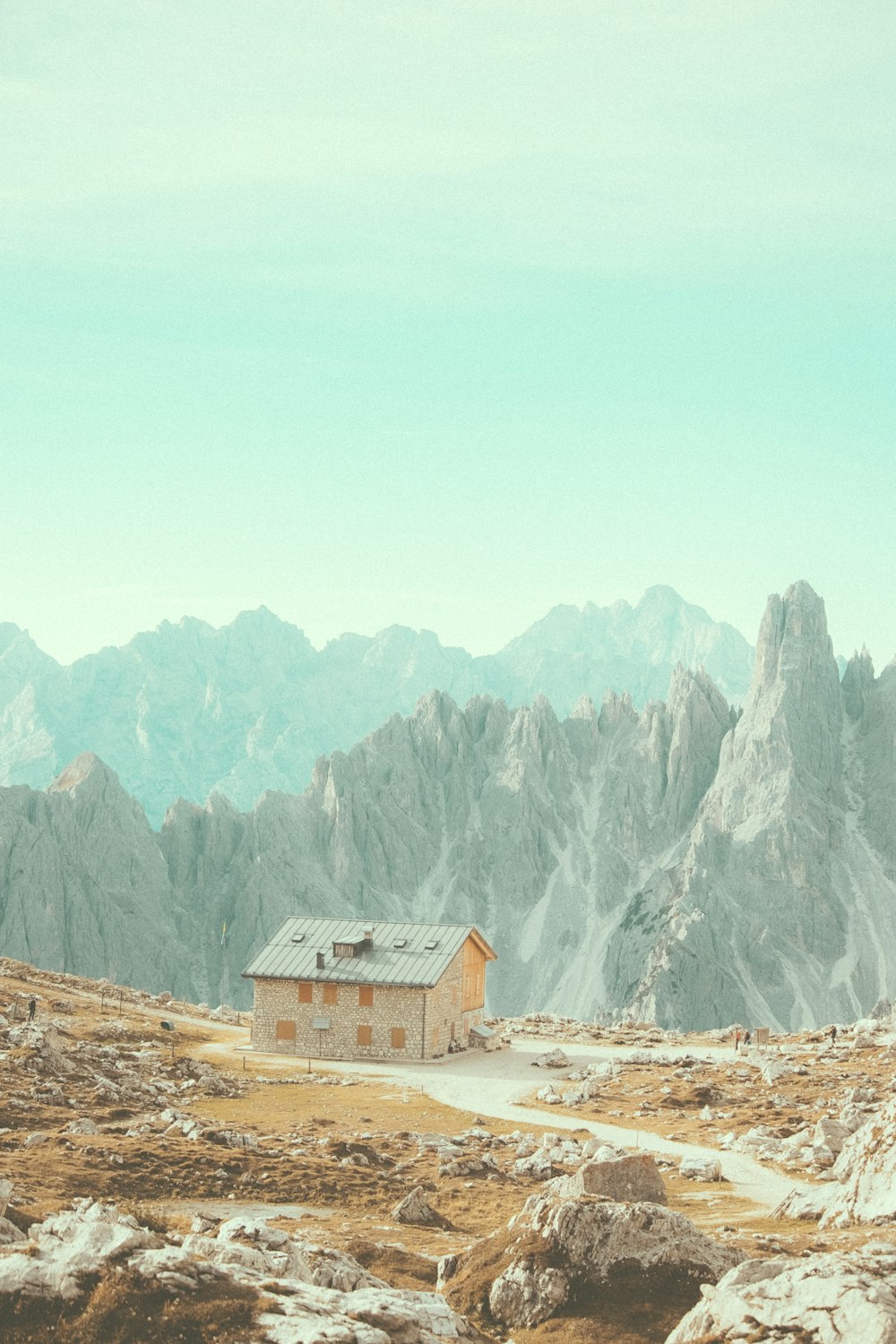 a house in the middle of a mountain range