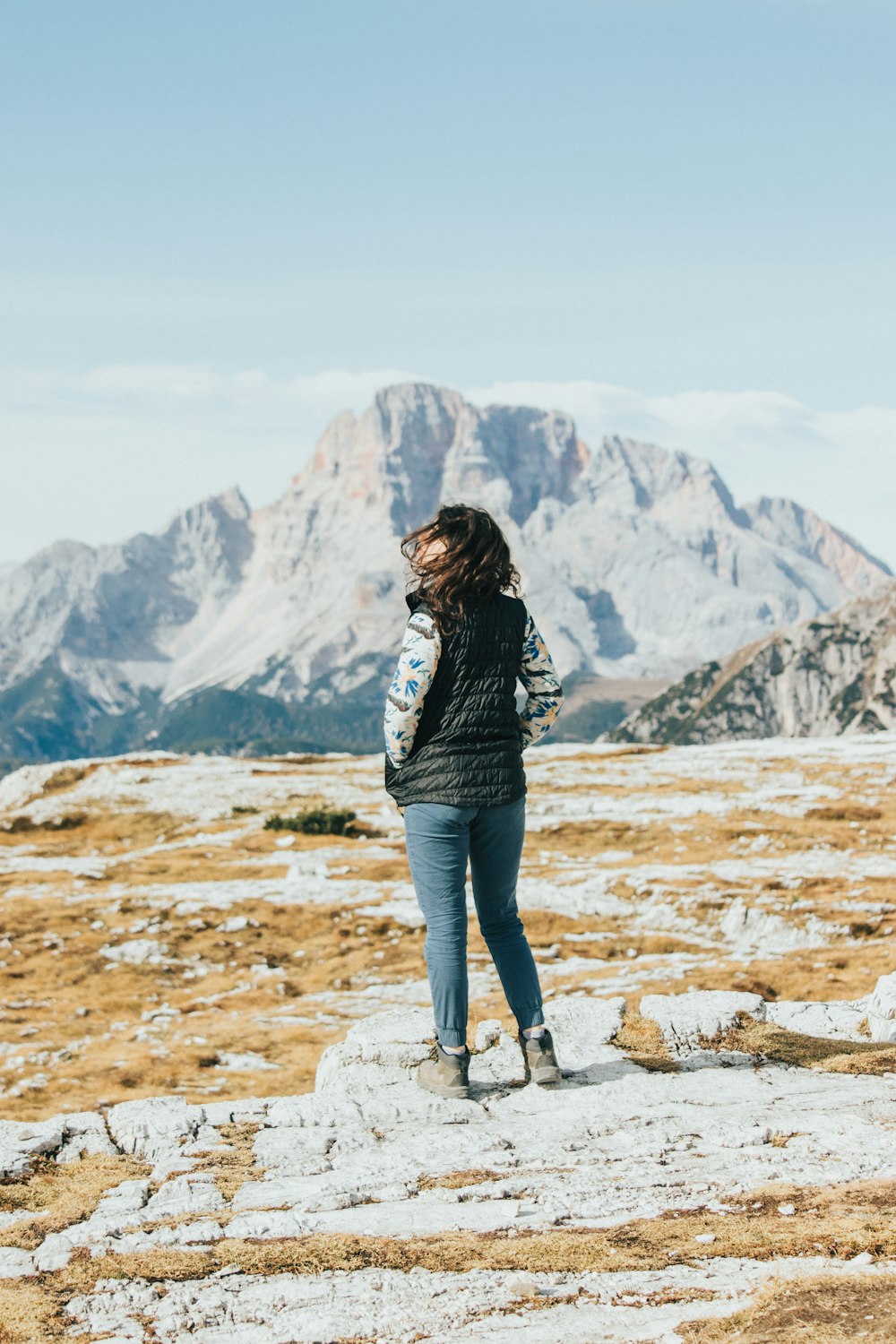 a woman standing on top of a mountain