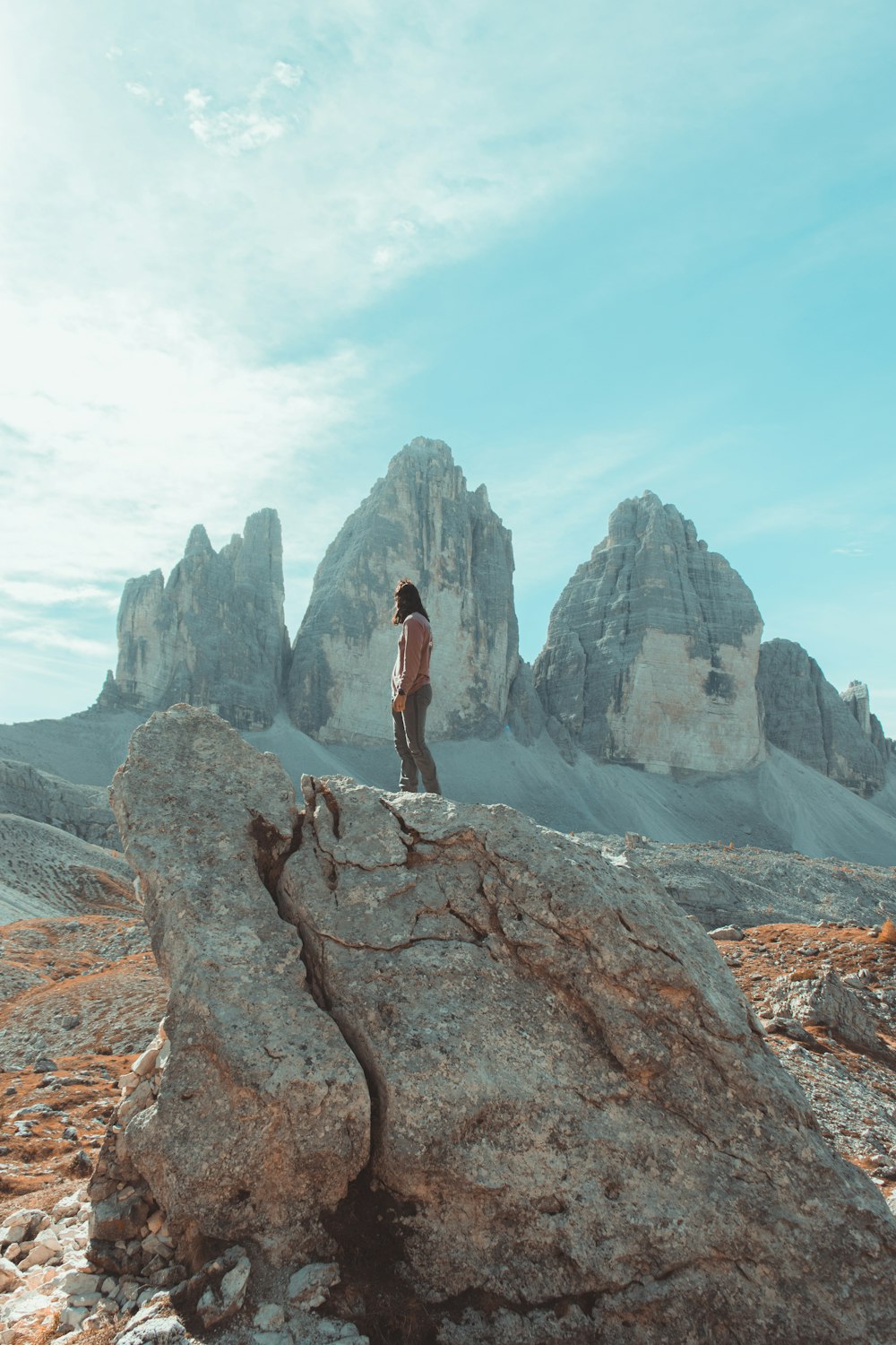 a man standing on top of a large rock