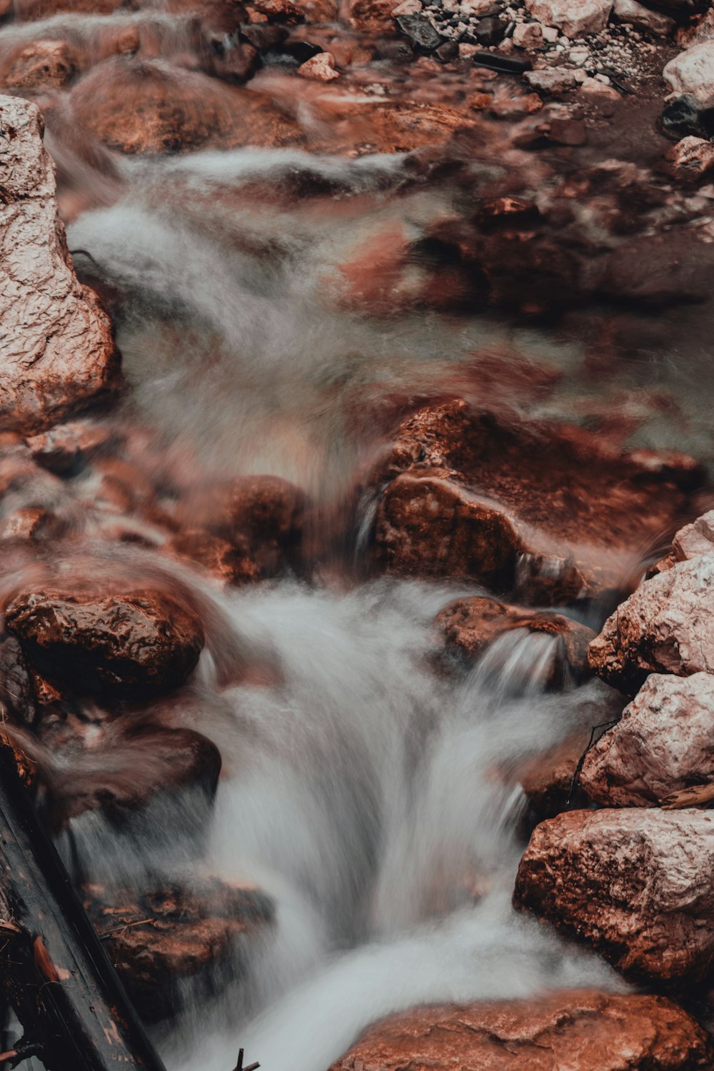 a stream of water running through a rocky area