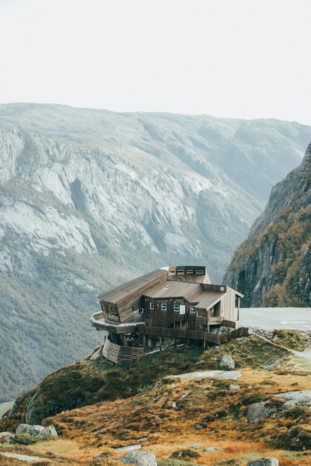 a house sitting on top of a lush green hillside