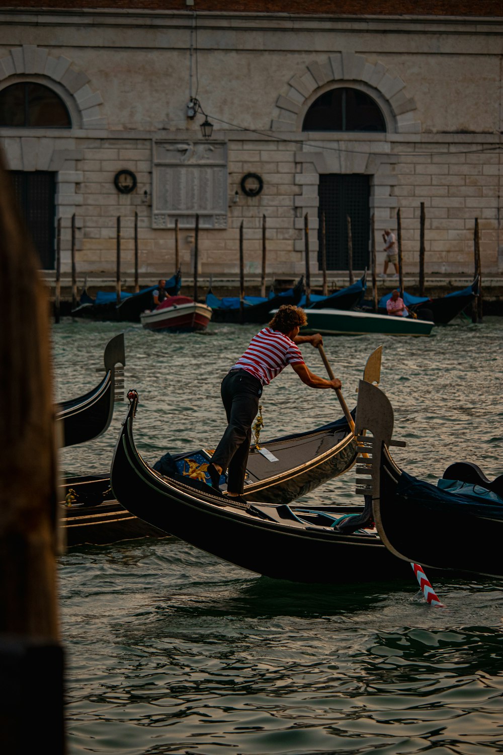 a person riding a gondola on a body of water