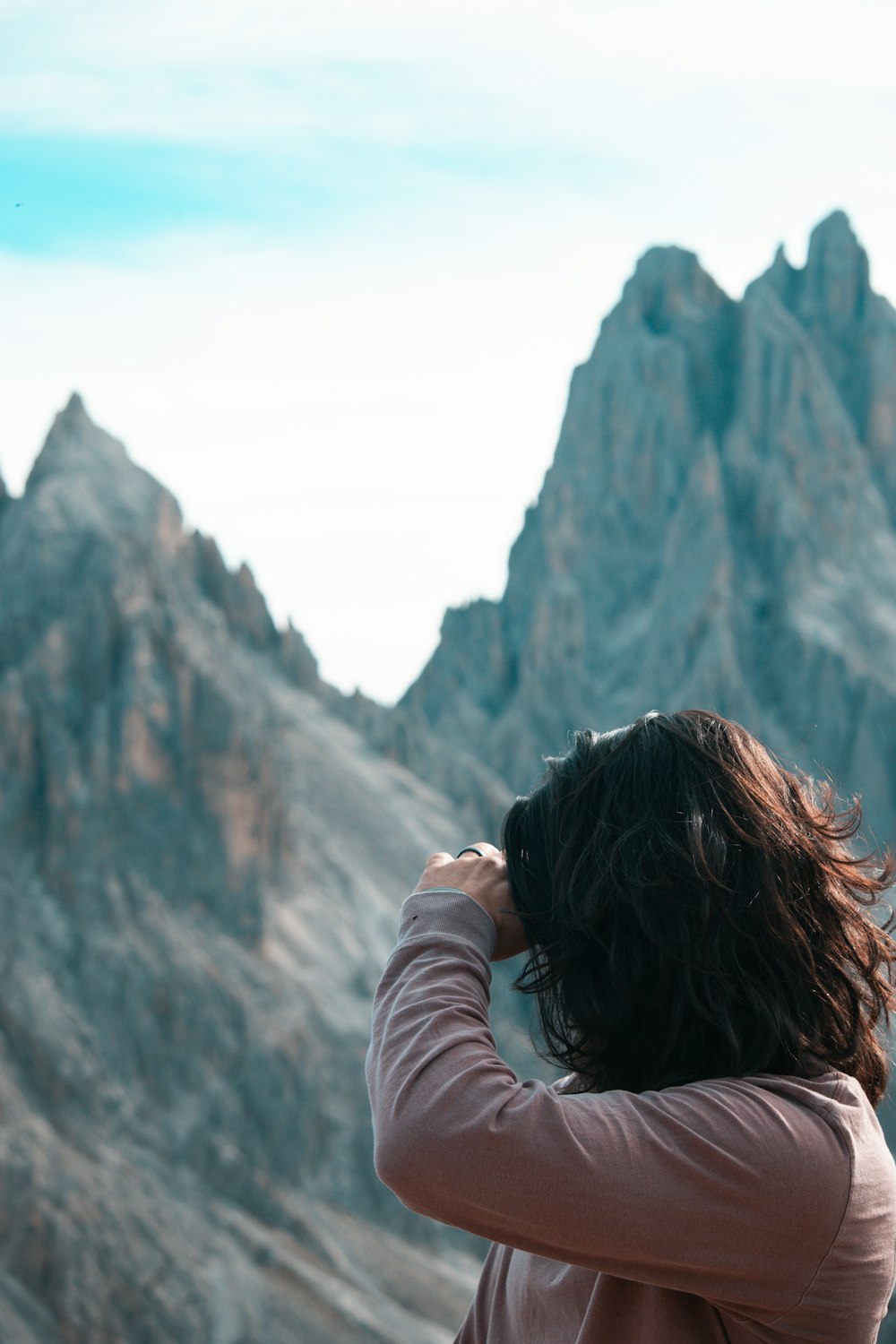 a woman standing in front of a mountain