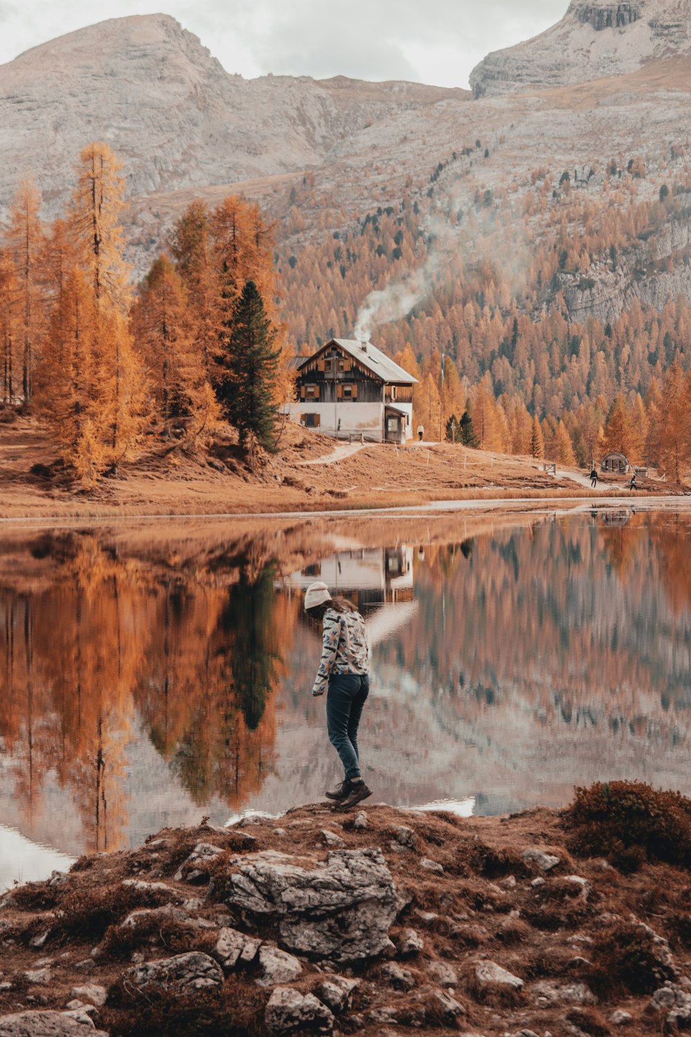 a person standing on a rock near a body of water