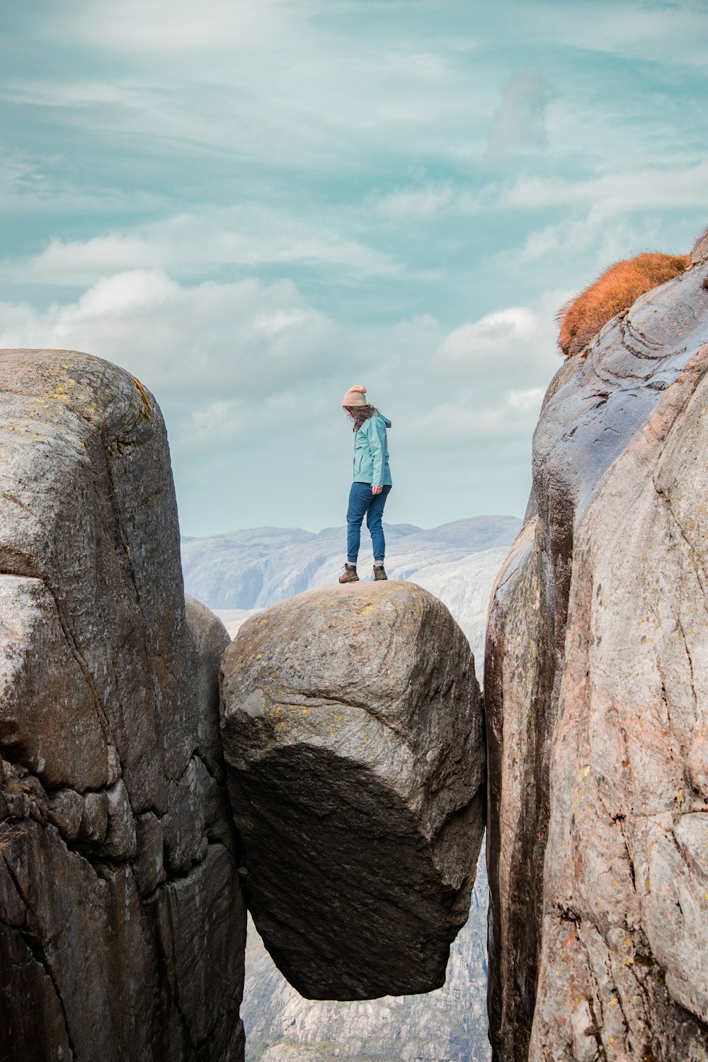 une personne debout au sommet d’une formation rocheuse