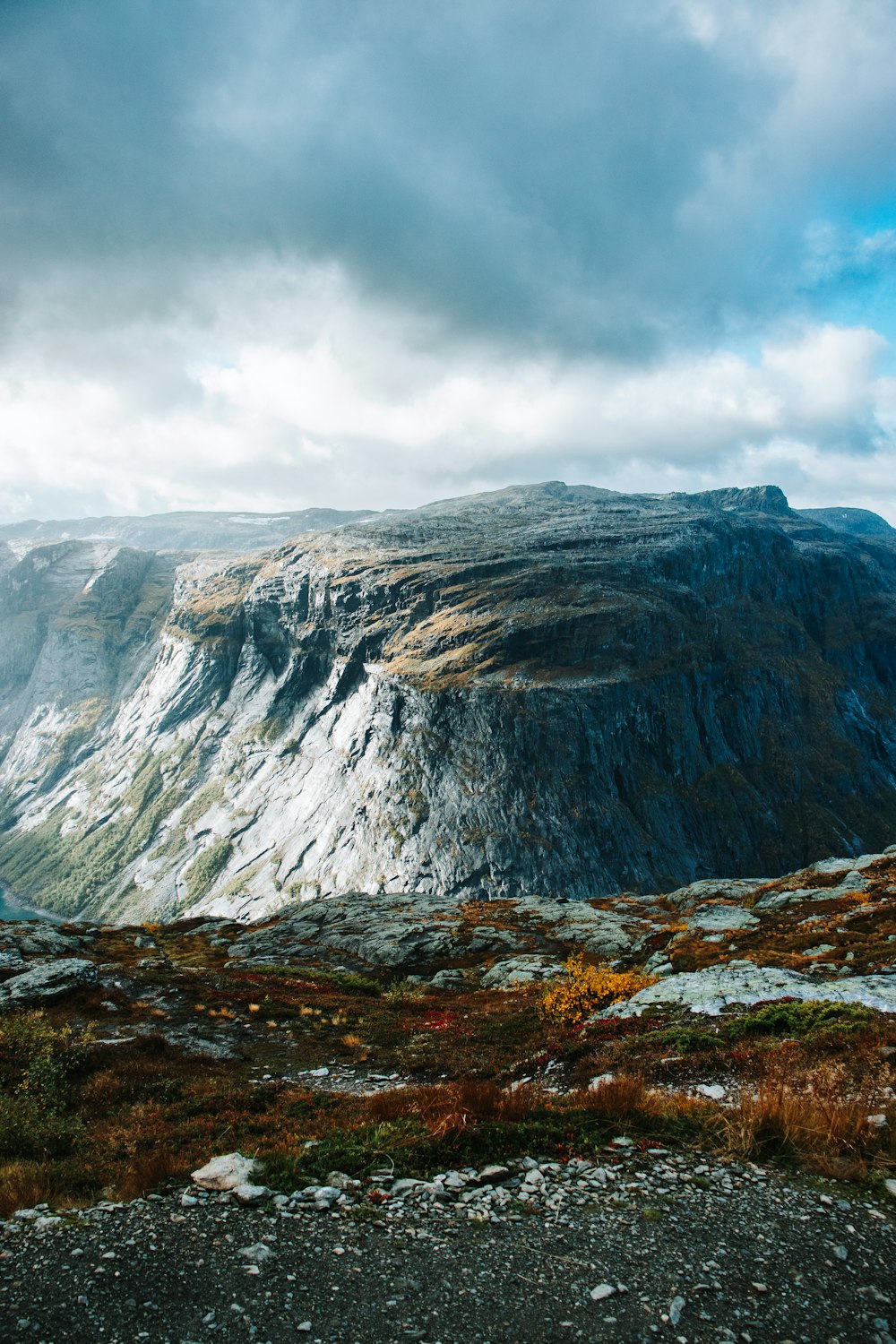 a large mountain with a very tall mountain in the background