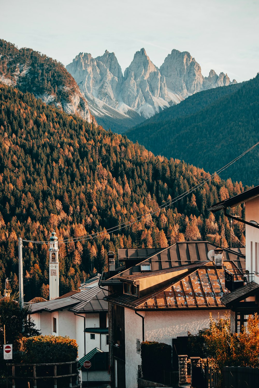 a view of a mountain range with a clock tower in the foreground