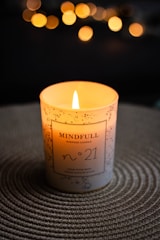 a lit candle sitting on top of a table