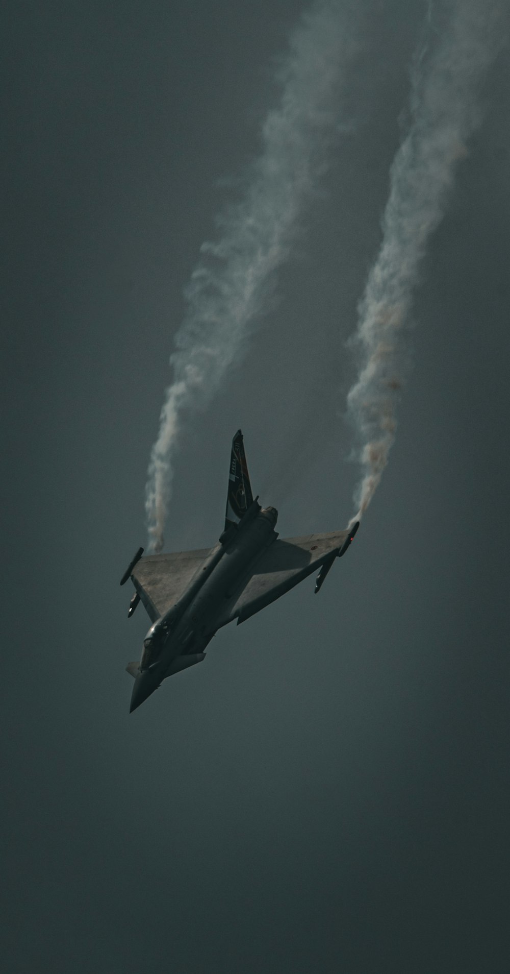 Un avion de chasse volant dans un ciel nuageux