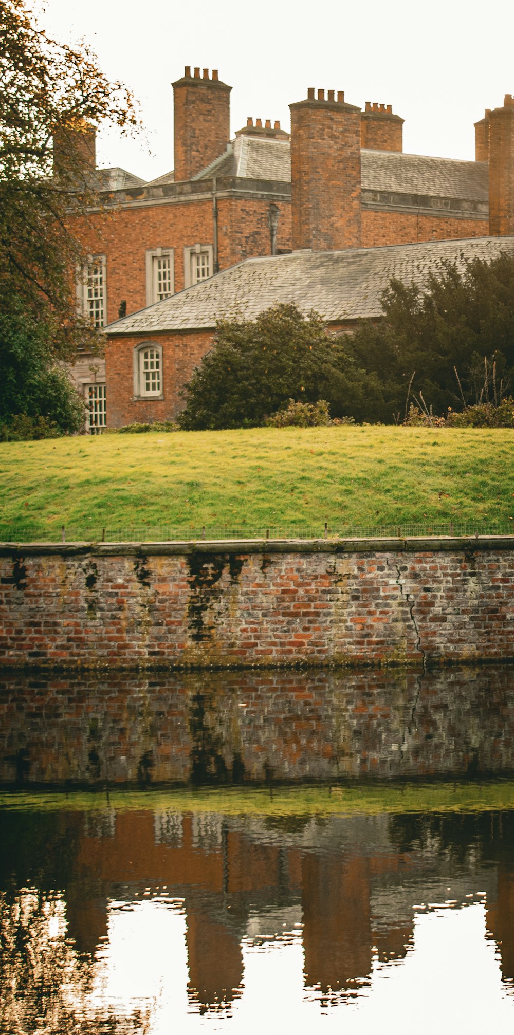 a large brick building sitting next to a body of water