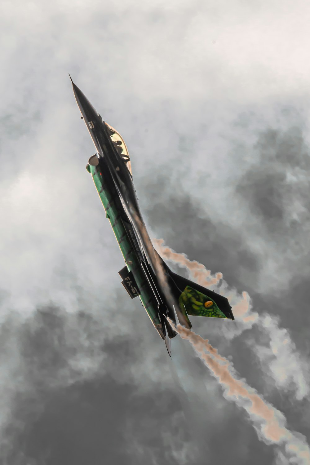 a fighter jet flying through a cloudy sky