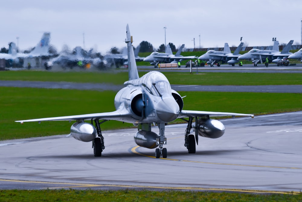 a fighter jet taking off from an airport runway