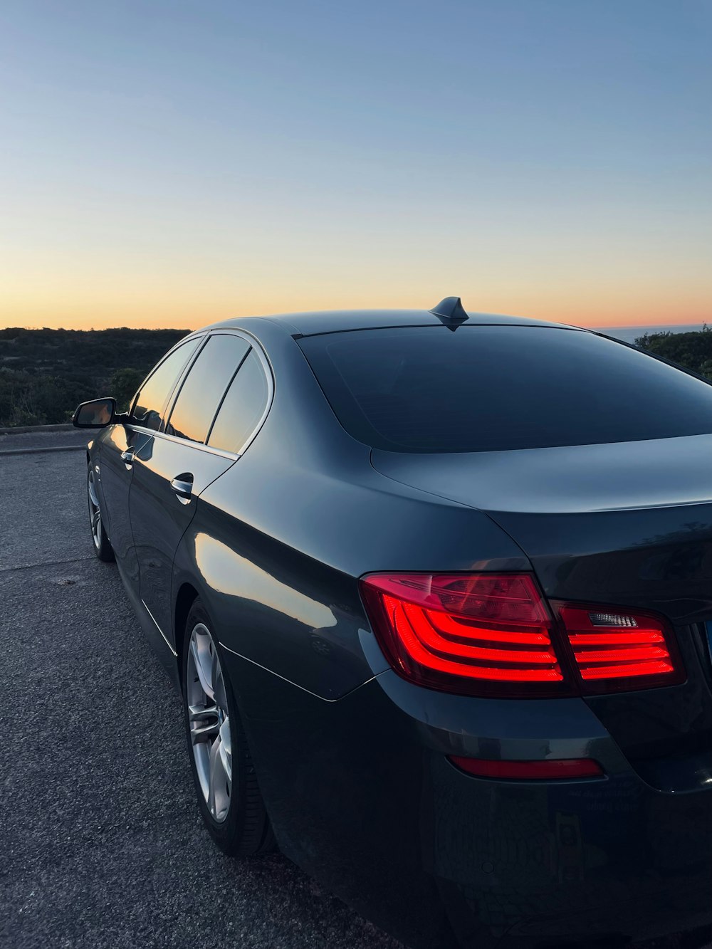 a black car parked on the side of the road